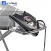 A close-up shot of a black and silver steam iron resting on a metal tray attached to an ironing board. Produktbild-Vorschau