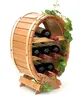 A wooden wine rack shaped like a barrel, holding six bottles of wine. It is decorated with artificial ivy. Náhled obrázku produktu