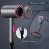 A hairdryer is shown with a removable filter and a hook for hanging. The hairdryer is grey with pink accents. Produktbild-Vorschau