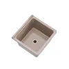 A top-down view of a beige sink basin with a black drain. Anteprima dell’immagine prodotto