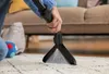 A person is using a handheld carpet cleaner on a rug. Anteprima dell’immagine prodotto