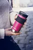 A person holding a pink Contigo travel mug outdoors. Anteprima dell’immagine prodotto