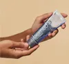 Hands holding a tube of toothpaste. Produktbild-Vorschau