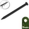A black ground stake is shown diagonally on a white background, with a close-up inset of multiple stakes and a corner showing grass with a circular cutout and the brand name. Produktbild-Vorschau
