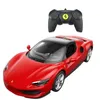 A red remote-controlled Ferrari car with a black roof and a black remote control. Produktbild-Vorschau