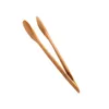 A pair of wooden kitchen tongs against a white background. Podgląd zdjęcia produktu