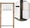 A wooden drying rack with black loops is shown next to a white wall and a dark doorway. An arrow indicates the rack is being moved into the doorway. Podgląd zdjęcia produktu