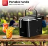 An ice maker is shown on a wooden table outdoors, with drinks and people in the background. Náhled obrázku produktu