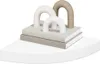 A decorative shelf with books and abstract sculptures. Produktbild-Vorschau