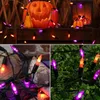 A collage of images showing Halloween-themed LED string lights in various settings, including near a jack-o'-lantern and on greenery. Produktbild-Vorschau