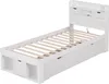 A white single bed frame with a headboard featuring storage compartments and drawers, shown from a diagonal angle against a white background. Podgląd zdjęcia produktu