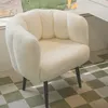 A white, fluffy armchair with a scalloped back is shown in a room with a checkered floor. Produktbild-Vorschau