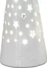 A close-up of the bottom portion of a white ceramic Christmas angel figurine with cut-out star and dot patterns illuminated from within. Produktbild-Vorschau