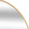 A close-up view of the edge of a round mirror with a gold metal frame. Produktbild-Vorschau