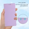 A hand holding a violet phone case against a sky background, with a close-up inset showing cutouts and wireless charging symbols. Produktbild-Vorschau