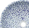 A close-up view of the interior of a round ceramic sink with a blue floral pattern. Náhled obrázku produktu