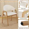 A white upholstered chair with wooden legs is shown in a room with a circular rug. The image is divided into sections highlighting different features of the chair. Podgląd zdjęcia produktu