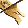 A close-up view of a wooden book stand with Arabic calligraphy. Produktbild-Vorschau