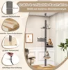A multi-level cat tree with several platforms and a hammock, set up in a room with furniture and a plant. Produktbild-Vorschau