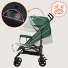 A green baby stroller is shown with diagrams illustrating its adjustable features and a close-up of a baby inside the canopy. Produktbild-Vorschau