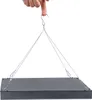 A hand holding a hook that suspends a black LED grow light by wires. Náhľad obrázku produktu