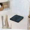 A digital scale is placed on a white countertop in a bathroom setting. Produktbild-Vorschau
