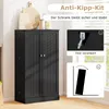 A black cabinet with two doors, shown in a room setting with some decorative items on top. The image also includes diagrams illustrating an anti-tip kit. Podgląd zdjęcia produktu