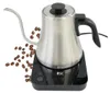 A stainless steel electric kettle with a gooseneck spout sits on its base, surrounded by coffee beans. Produktbild-Vorschau
