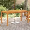 An outdoor patio setting with a wooden table and chairs, featuring drinks on the table.