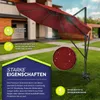 A red cantilever umbrella is set up on a green lawn in front of a house. Produktbild-Vorschau