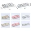 A collage of images showing different colored egg holders, with dimensions indicated on some. Produktbild-Vorschau
