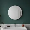 A round bathroom mirror with LED lighting above a sink with a faucet, toothbrush holder, and soap. Produktbild-Vorschau