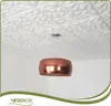 A copper pendant light hangs from a white, geometrically textured ceiling. Podgląd zdjęcia produktu
