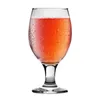A single glass of pink beverage with condensation on the outside, isolated on a white background. Podgląd zdjęcia produktu