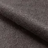 A close-up view of dark gray bouclé fabric, likely a bed frame. Náhľad obrázku produktu