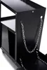 A close-up view of a black metal welding cart with chains attached. Produktbild-Vorschau