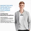 A man wearing a blazer and t-shirt, with wireless headphones around his neck. Produktbild-Vorschau