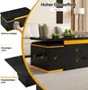 A modern coffee table with integrated stools and storage, shown in a living room setting with decorative elements. Voir les images du produit