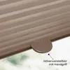 Close-up of a brown pleated blind with a handle, with a hint of greenery visible through the window. Produktbild-Vorschau