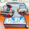 A person is shown using vacuum compression bags to pack clothes into a suitcase, with close-up insets illustrating the process. Náhled obrázku produktu