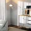 A modern living room corner with a floor lamp, a sofa, and a cabinet. Podgląd zdjęcia produktu