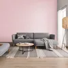 A living room scene with a gray sectional sofa, coffee table, rug, and a floor lamp. Produktbild-Vorschau