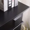 A close-up view of a black wooden surface, possibly a table or shelf, with the spines of several books visible on top. Anteprima dell’immagine prodotto