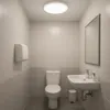 A clean, modern bathroom with a toilet, sink, and paper towel dispenser. Náhľad obrázku produktu