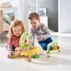 Two children playing with a wooden marble run toy in a room. Anteprima dell’immagine prodotto