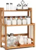 A three-tiered bamboo spice rack filled with various jars and containers. Anteprima dell’immagine prodotto