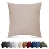 A large taupe pillow is shown in the foreground, with a row of smaller bedding sets in various colors displayed below it. Produktbild-Vorschau