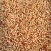 A close-up, overhead view of a mixture of bird seeds, including millet and oats. Produktbild-Vorschau