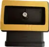 A black rectangular plumbing fitting with a yellow adhesive gasket is shown against a white background. Produktbild-Vorschau
