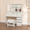 A white vanity table with a mirror and storage compartments, along with a matching stool, is shown in a room. Produktbild-Vorschau